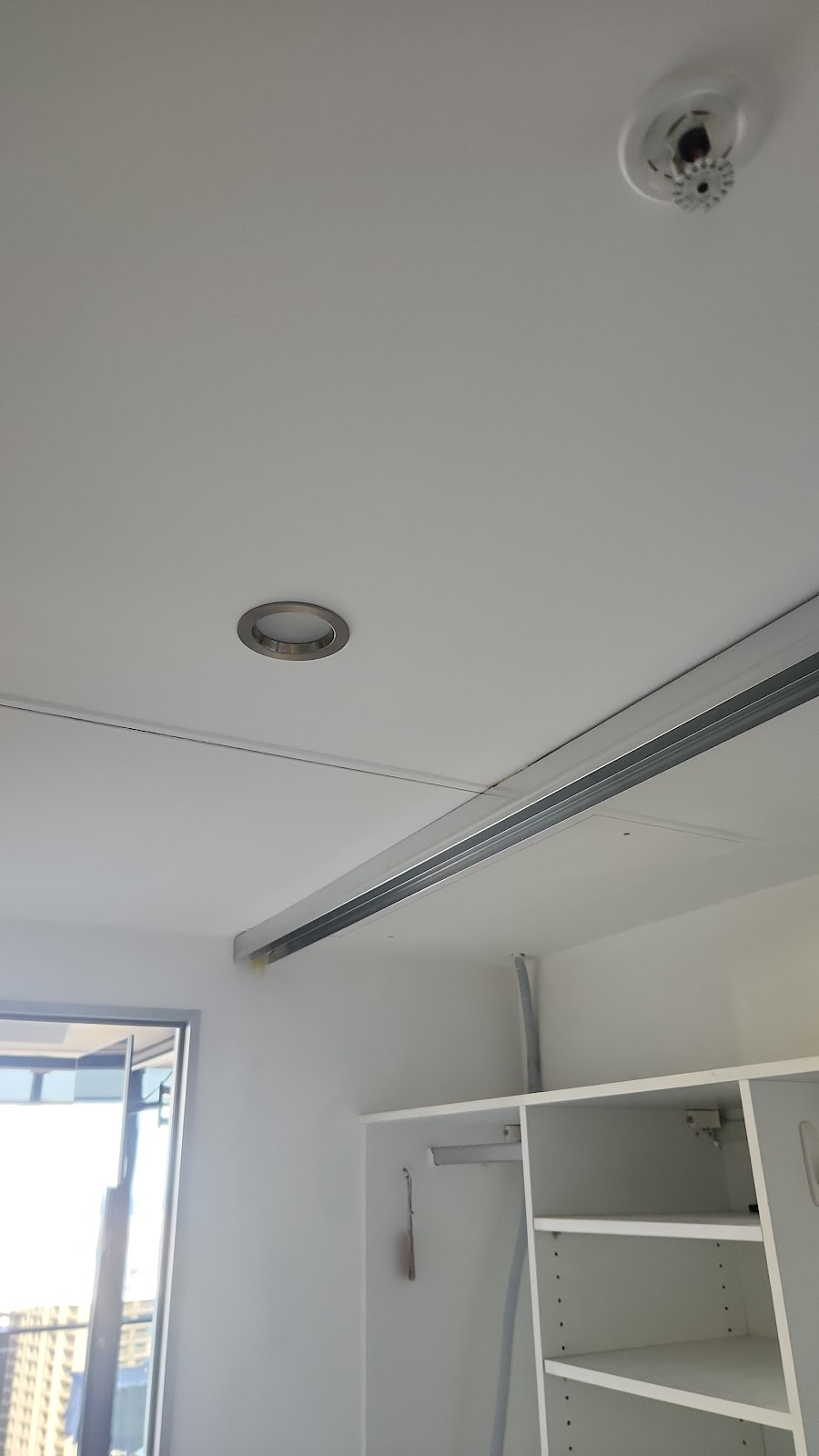Freshly repaired and painted white ceiling and robe