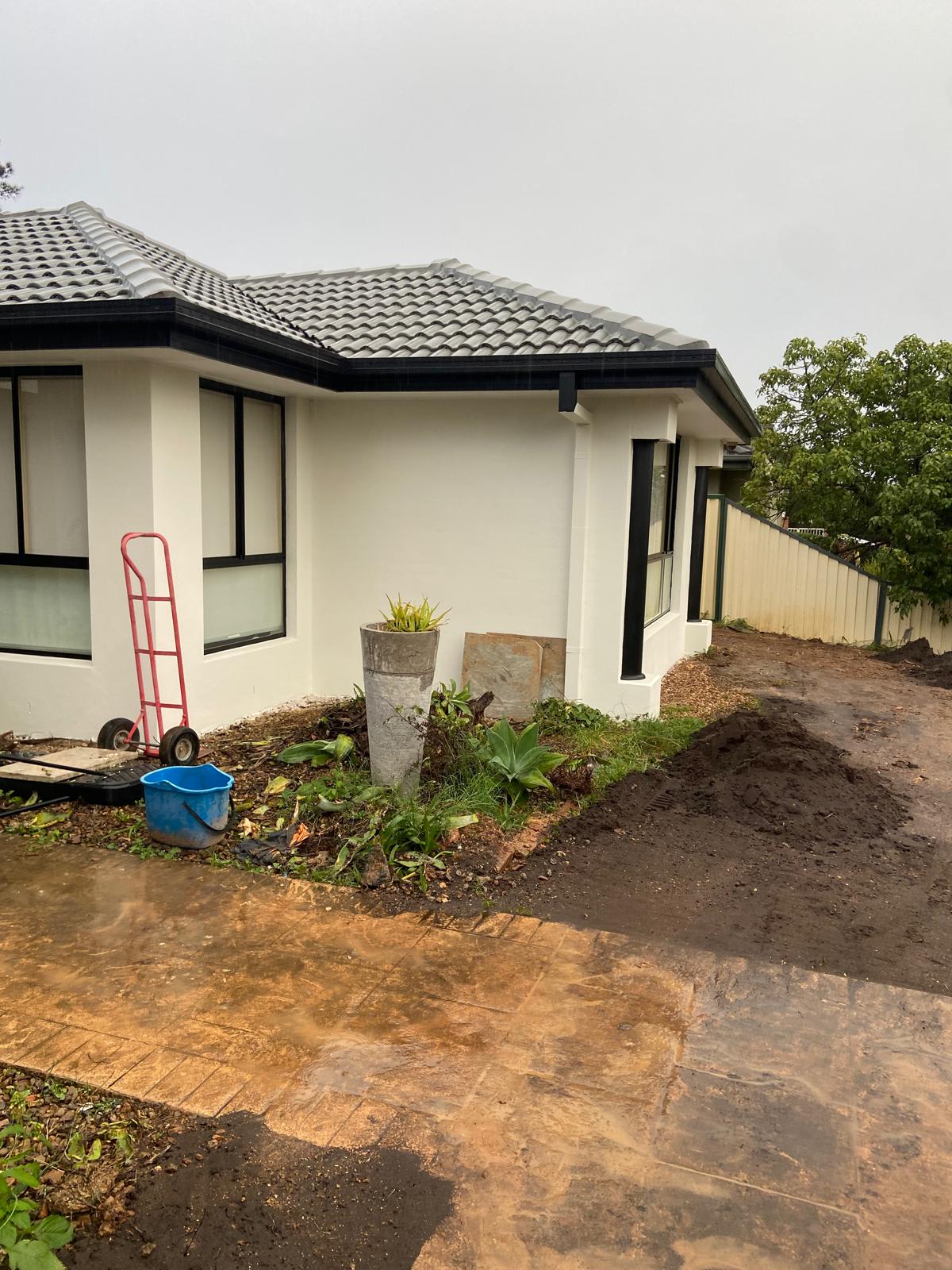 Single storey home freshly painted white with dark trims